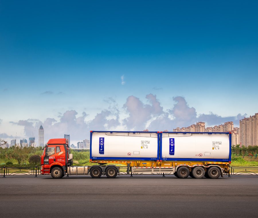 A truck driving on a road with two EXSIF tanks